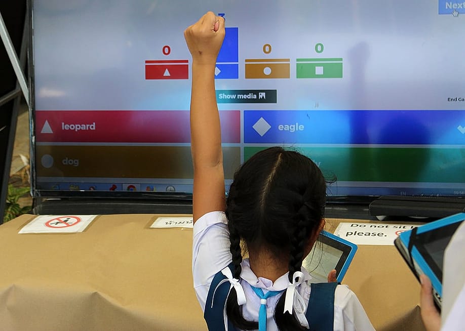 A young student celebrates a correct answer in an educational online game. — Hi-Point // Shutterstock