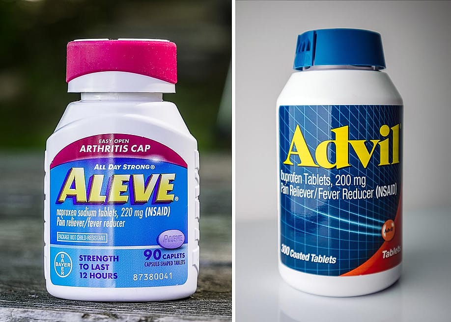 Composite image of a bottle of Aleve with a pink cap on an outdoor table and a bottle of Advil with a blue cap on a white surface. — Miro Vrlik Photography, KK Stock // Shutterstock