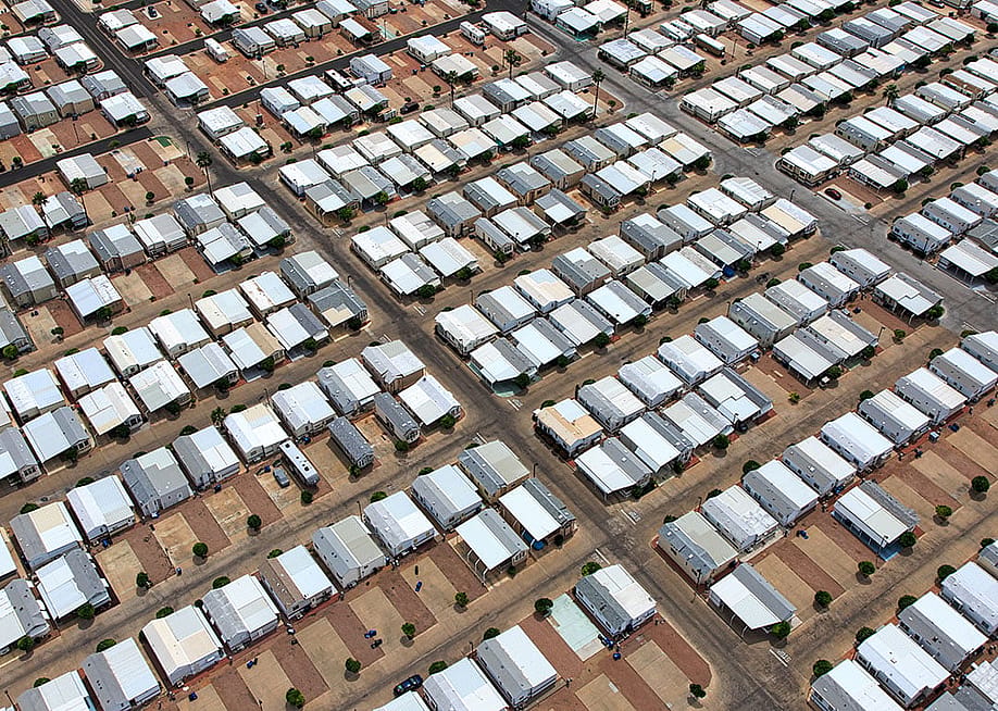 Aerial view of mobile home park in the Arizona desert. — Tim Roberts Photography // Shutterstock
