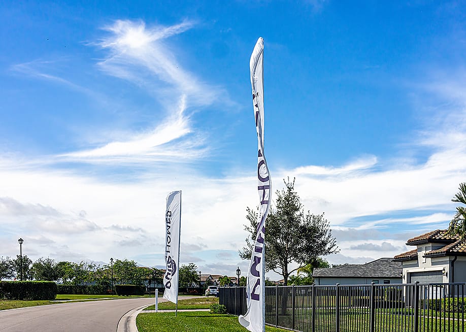 Sign banner flags outside a residential home community built by developer company, Pulte PulteGroup, in Florida. — Kristi Blokhin // Shutterstock