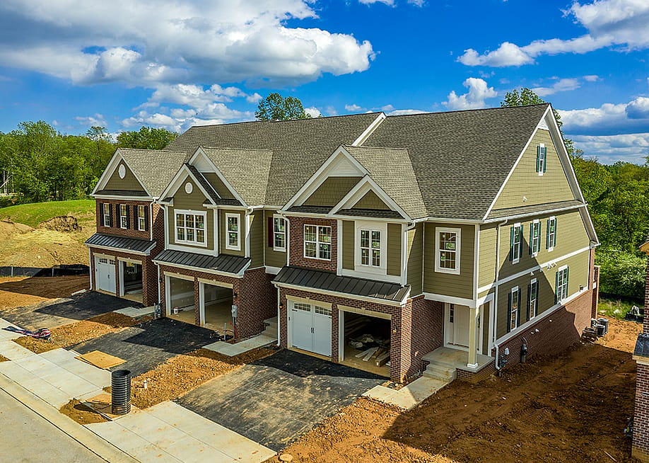 A large, modern triplex home nearing completion. — tokar // Shutterstock