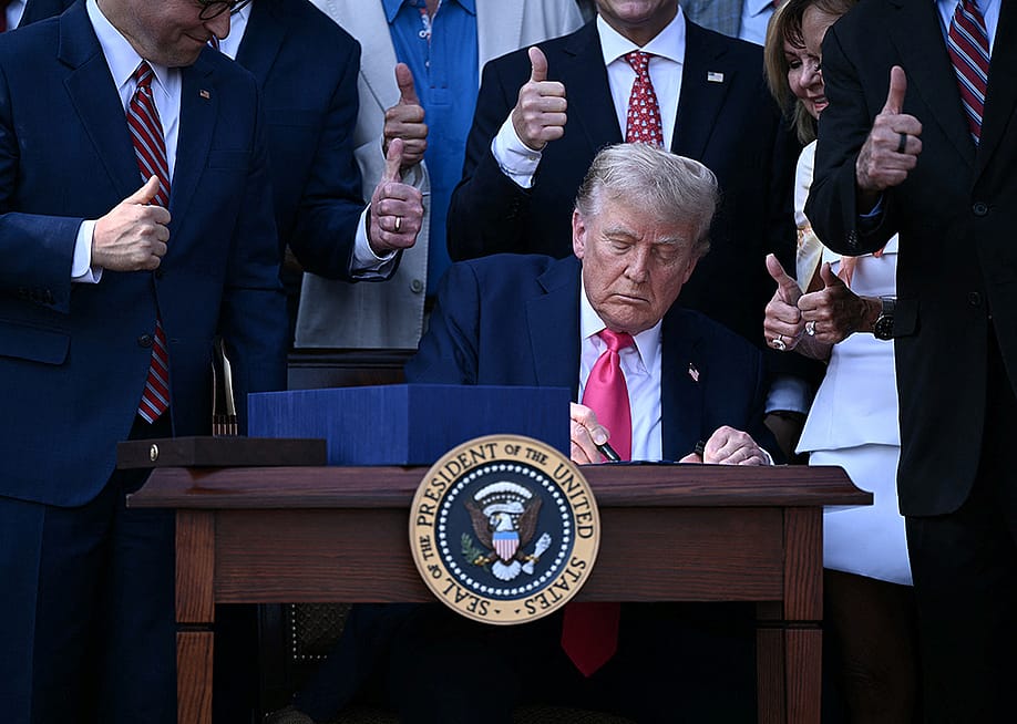 US President Donald Trump signs the 'Big Beautiful Bill Act' at the White House in Washington, DC on July 4, 2025. — BRENDAN SMIALOWSKI // POOL / AFP via Getty Images