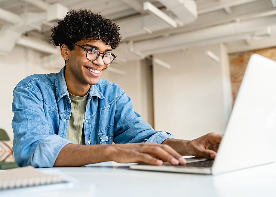 A young freelancer using a laptop to work remotely. — Inside Creative House // Shutterstock
