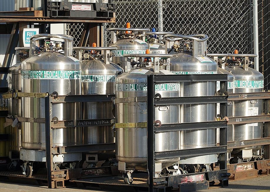 Industrial Oxygen cylinders waiting in racks outside filled and waiting to be put into use in Watsonville , California. — Michael Barajas // Shutterstock