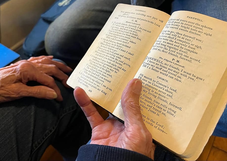'Amazing Grace' as it appears in Ginny Hawker's family heirloom songbook, Lloyd’s Primitive Baptist Hymns. You can see stains in the margins, left by the tobacco-covered hands of her aunt Annie Maud Puckett. — Zack Harold for The Daily Yonder