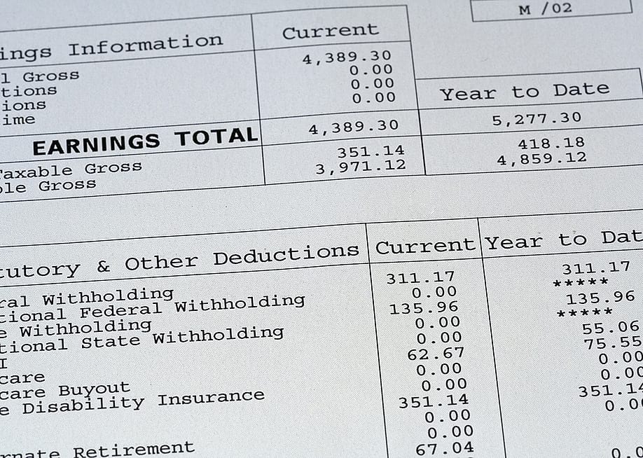 A close up view on a pay stub. — Josh randall // Shutterstock