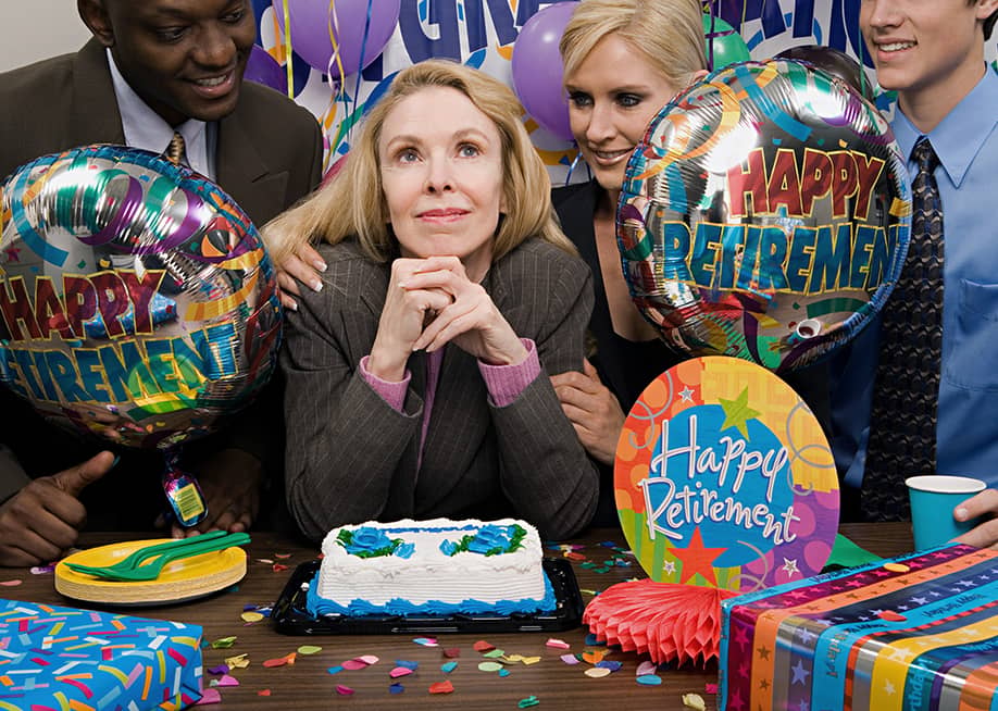 A female employee surrounded by her colleagues during her retirement party. — XiXinXing // Shutterstock
