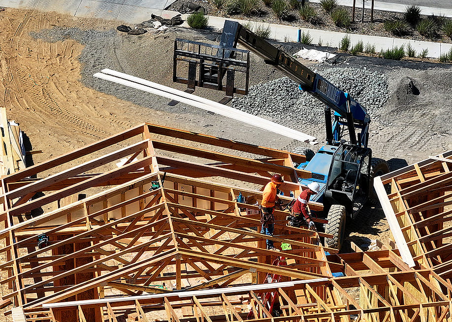 Aerial view of a home under construction with workers present on site in San Rafael, California. — Photo by Justin Sullivan // Getty Images