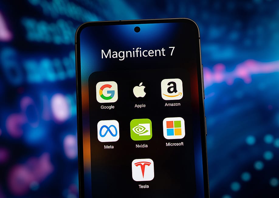 A smartphone's app folder named 'Magnificent 7' and displays app icons of Google, Apple, Amazon, Meta, Nvidia, Microsoft, and Tesla. — gguy // Shutterstock