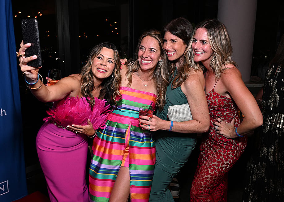 Marisa Peters (2nd L) poses for a selfie with guests at the BE SEEN Gala on June 7, 2025 at Harriet's Rooftop in Los Angeles, California. — Photo by Michael Kovac // Getty Images for The BE SEEN Foundation