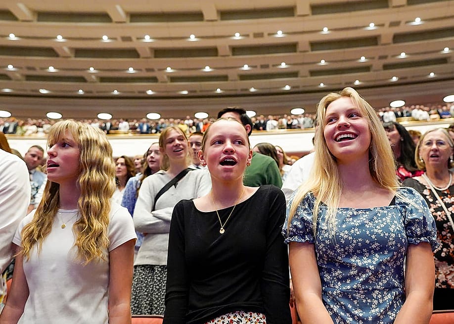 Low angle view of young women singing a hymn during a session of General Conference of The Church of Jesus Christ of Latter-day Saints in April 2025. — Chris Samuels // The Salt Lake Tribune