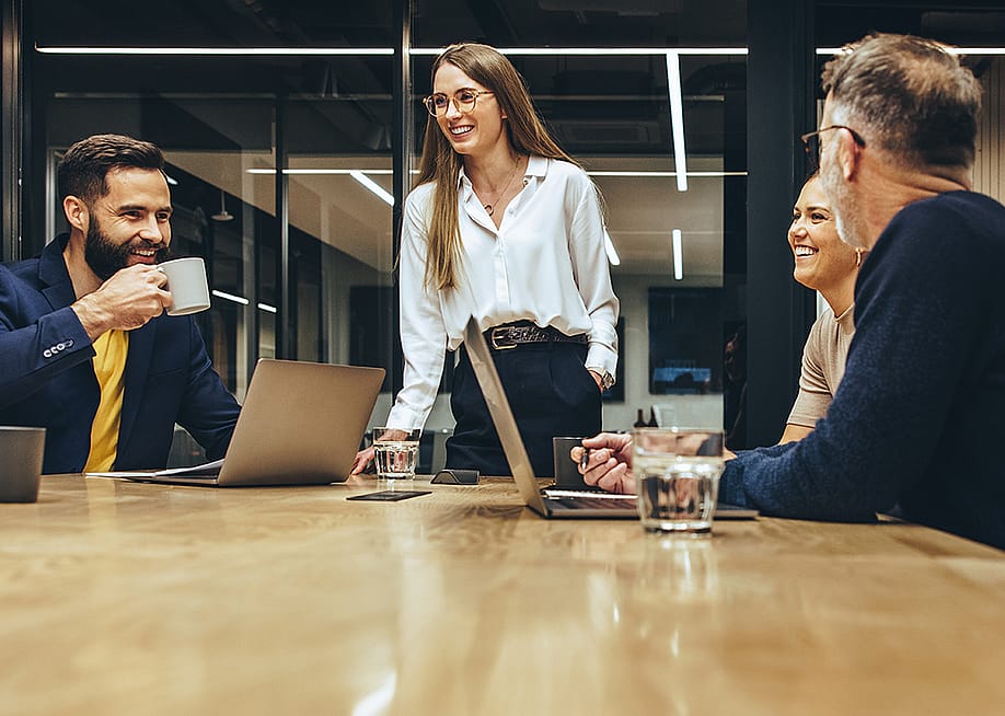 A happy business team having a meeting in a boardroom. — Jacob Lund // Shutterstock