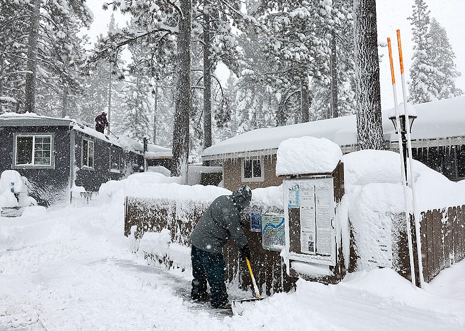 Mobile home owners shovel snow during a winter storm on March 02, 2024 in the Sierra Nevada mountains in Truckee, California. — Mario Tama // Getty Images