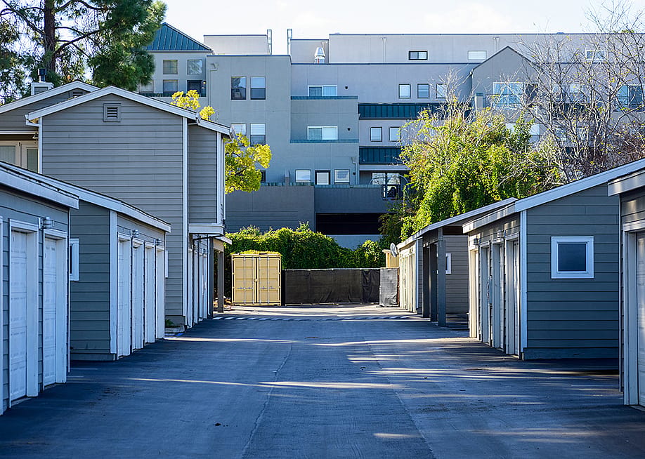 Symmetrical view of urban apartments' garages in a paved driveway. — Michael Vi // Shutterstock
