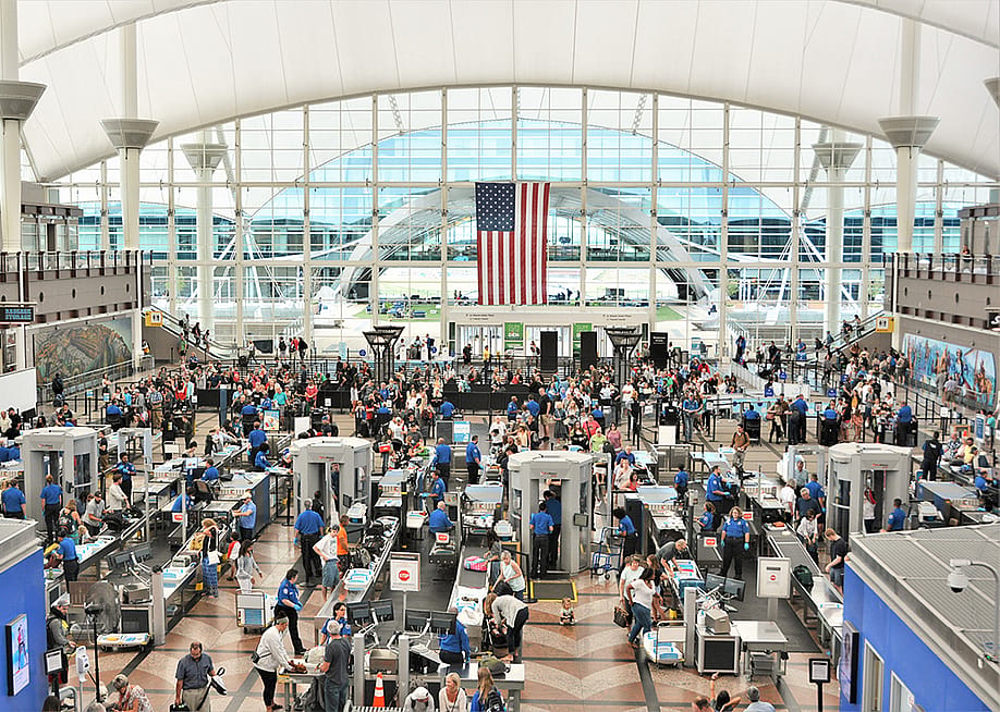 Travelers form long lines at the TSA screening areas of Denver International Airport. — Jim Lambert // Shutterstock