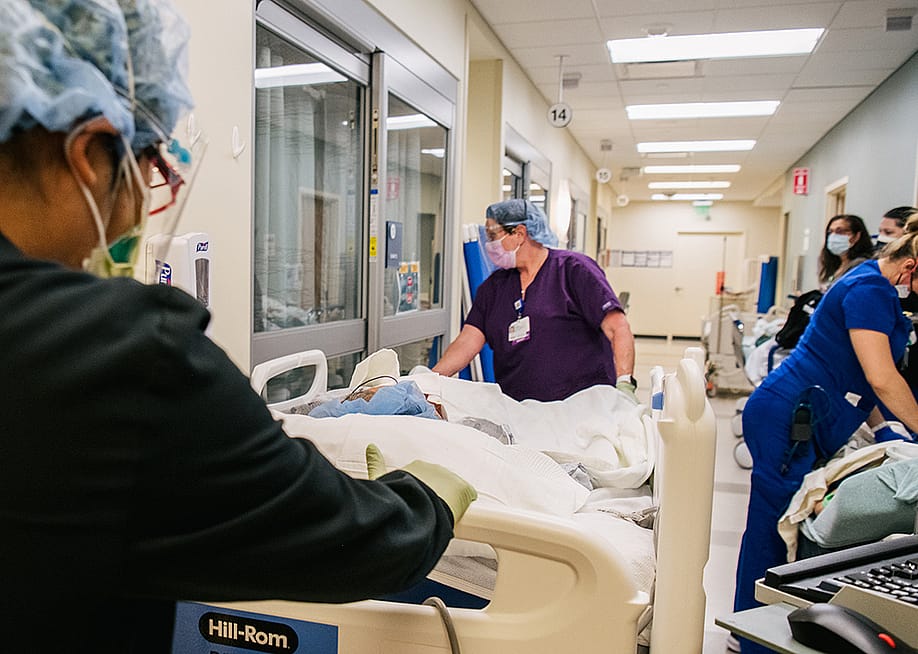 Emergency Room nurses fill a hallway as they tend to patients at the Houston Methodist The Woodlands Hospital in Texas. — Brandon Bell // Getty Images