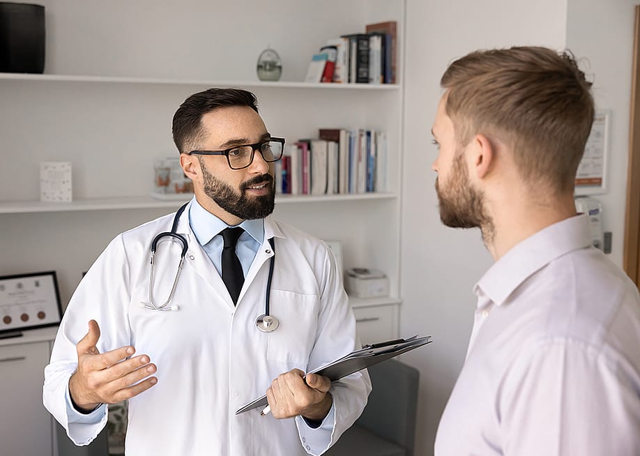 A young man consults with a physician. — fizkes // Shutterstock