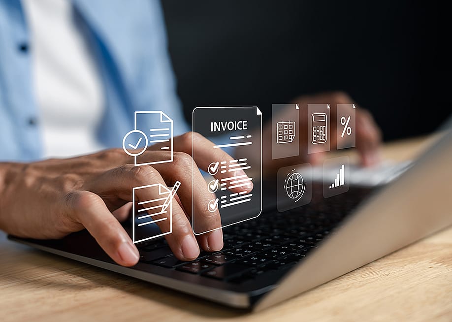 Business expense software concept using invoice graphics illustrated over a person using a laptop. — MMD Creative // Shutterstock