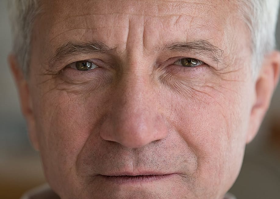 A close up photograph of a white elderly man. — fizkes // Shutterstock