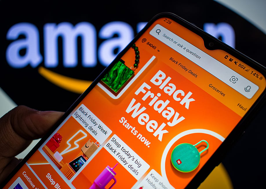 The 'Black Friday Week' banner on the Amazon app displayed on a smartphone. — Charles-McClintock Wilson // Shutterstock