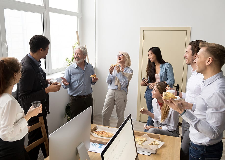 A happy business team having pizza in their office. — fizkes // Shutterstock