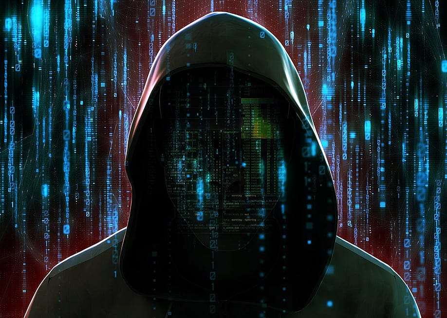 Illustration depicting cybersecurity concept with faceless figure of criminal in a hoodie against futuristic code background symbolizing AI technology. — liu yongqiang // Shutterstock