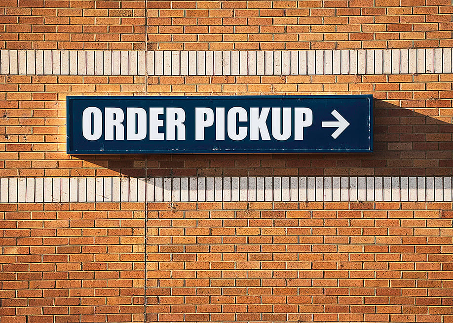 'Order pickup' sign pointing to the left at a store. — J.D.S // Shutterstock