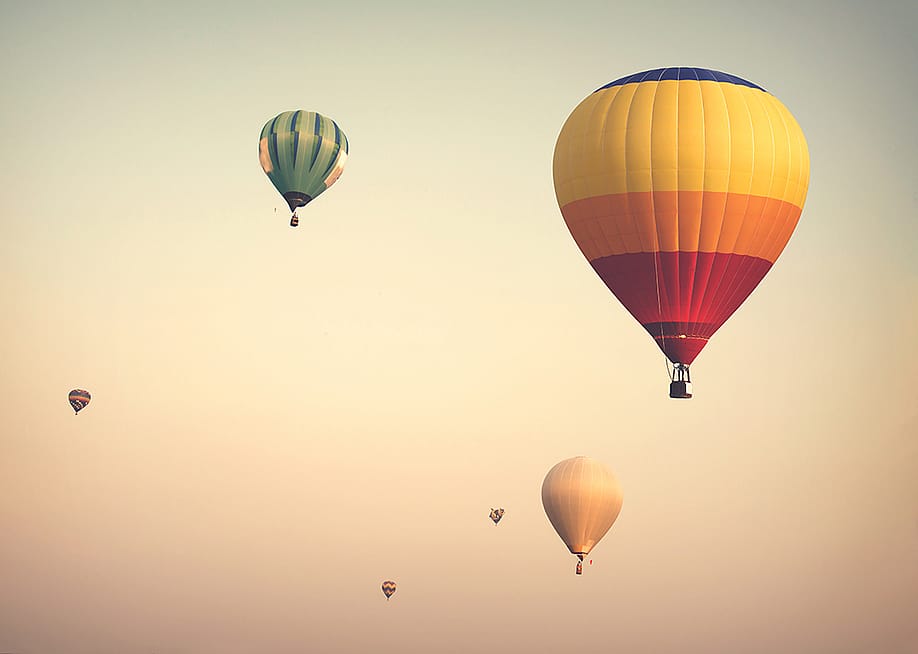 Hot air balloons up on a cloudy sky. — jakkapan // Shutterstock