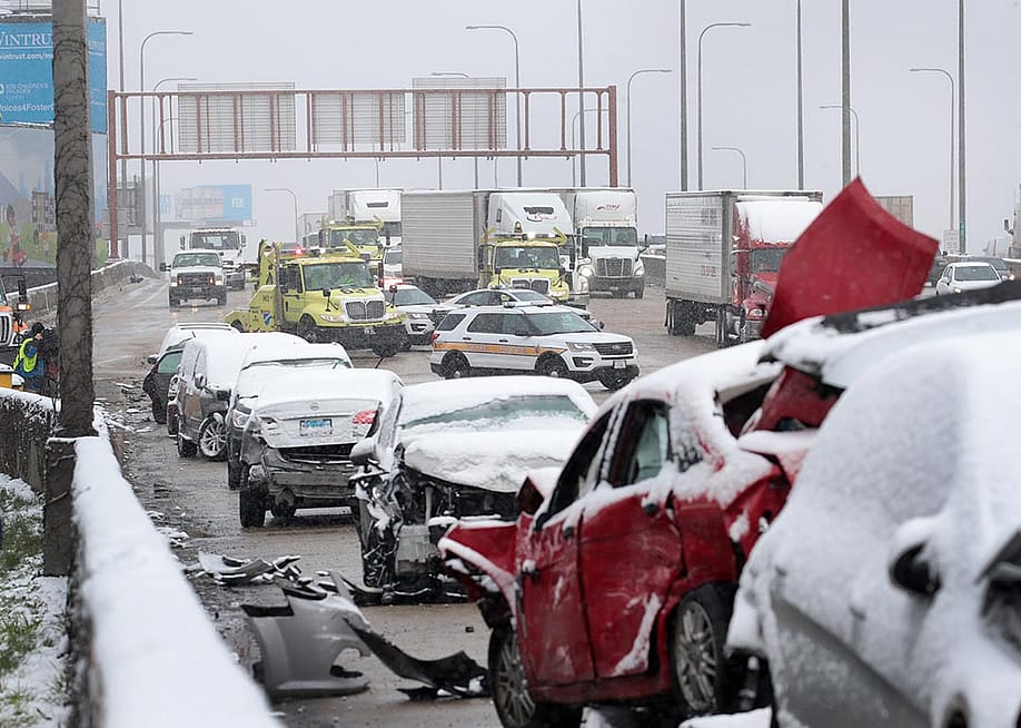 State police supervise the cleanup of a 54-car pileup in the snow on the Kennedy Expressway near downtown on April 15, 2020 in Chicago, Illinois. — Scott Olson // Getty Images