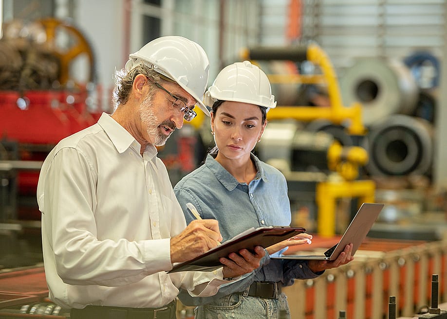 Engineers in an industrial factory conducting machine inspection. — worradirek // Shutterstock