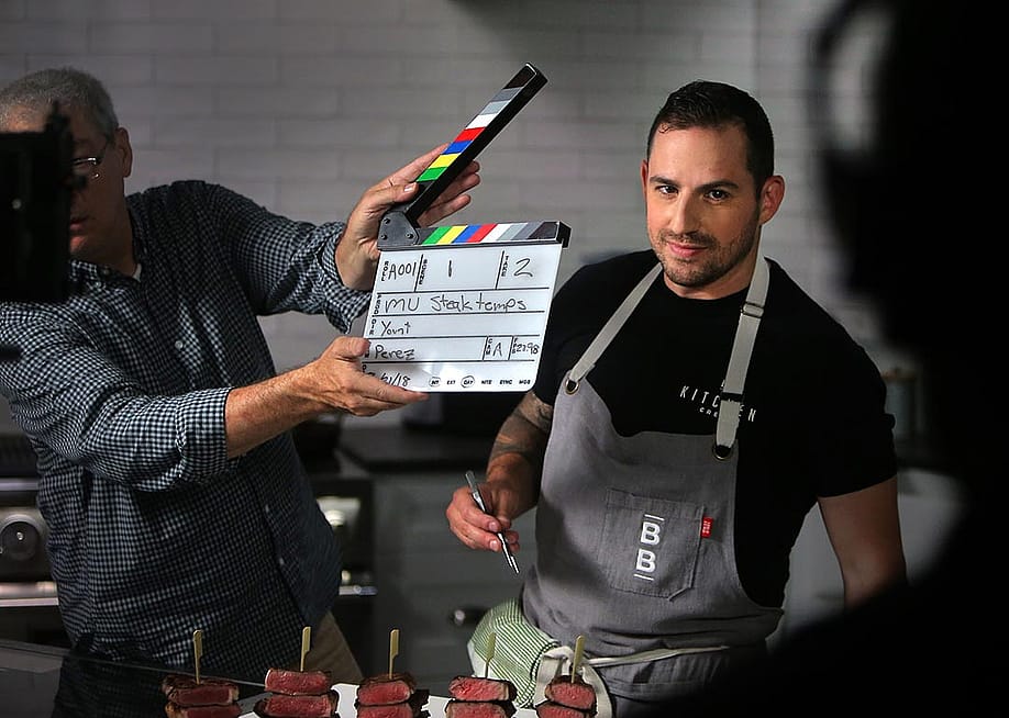 Yankel Polak, ButcherBox head chef, smiles while director and cinematographer Scot Yount snaps a slate at ButcherBox in Peabody, MA on Aug. 22, 2018. ButcherBox is a subscription based service for grass-fed beef - as well as humanely-raised pork and chicken. — Lane Turner // The Boston Globe via Getty Images