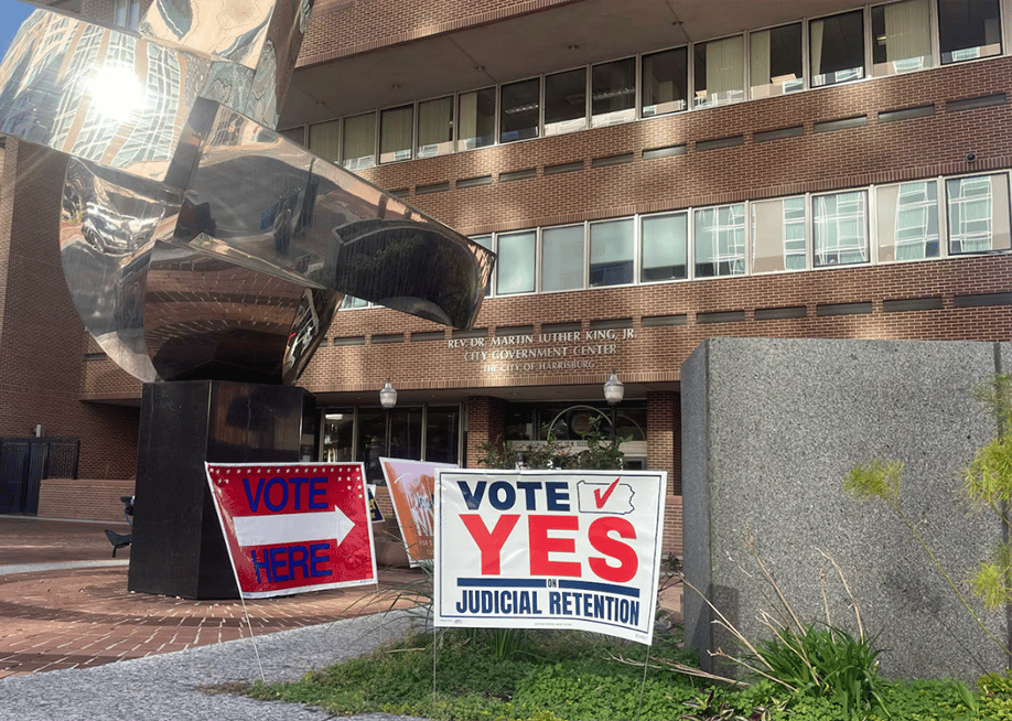 A sign urging voters to vote yes on judicial retention outside a polling place in Harrisburg, Pennsylvania, on Election Day. — Carter Walker for Votebeat