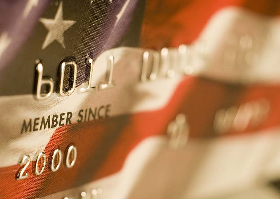 A close up of a credit card designed with the US flag. — Artifan // Shutterstock