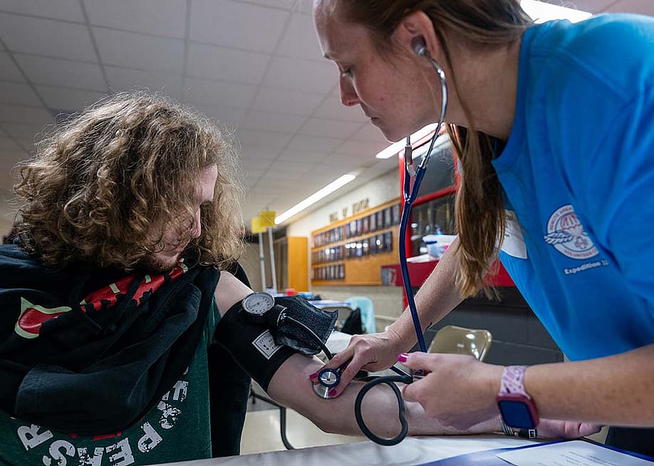 A high school student getting his blood pressure checked at a mobile medical clinic in Terre Haute South High School, Indiana. — Photo by Spencer Platt // Getty Images