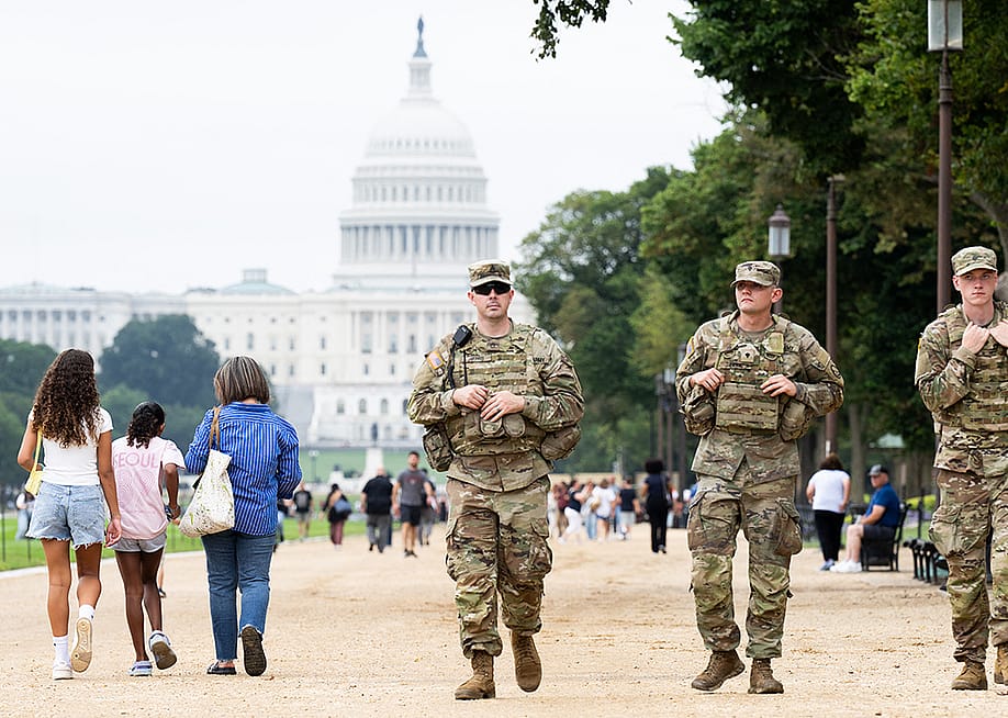Members of the National Guard walking among civilians as part of their patrolling near the US Capitol area in Washington, DC. — SAUL LOEB // AFP via Getty Images