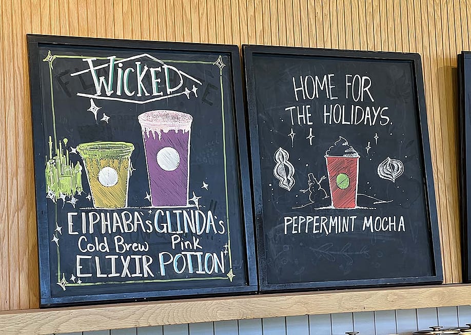 A chalkboard menu featuring Wicked x Starbucks' collaboration drinks. — Smith Collection // Gado/Getty Images