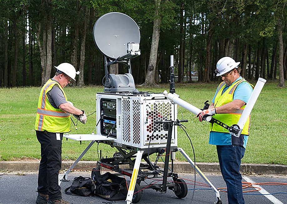 A technical staff setting up a portable satellite asset. — AT&T