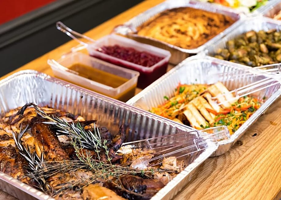 Thanksgiving dishes in catering dishes prepared on the table for serving. — CaterCow