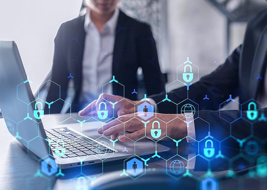 Two businesspeople in formal wear working on a project, with cyber security technology graphics illustrated. — VideoFlow // Shutterstock