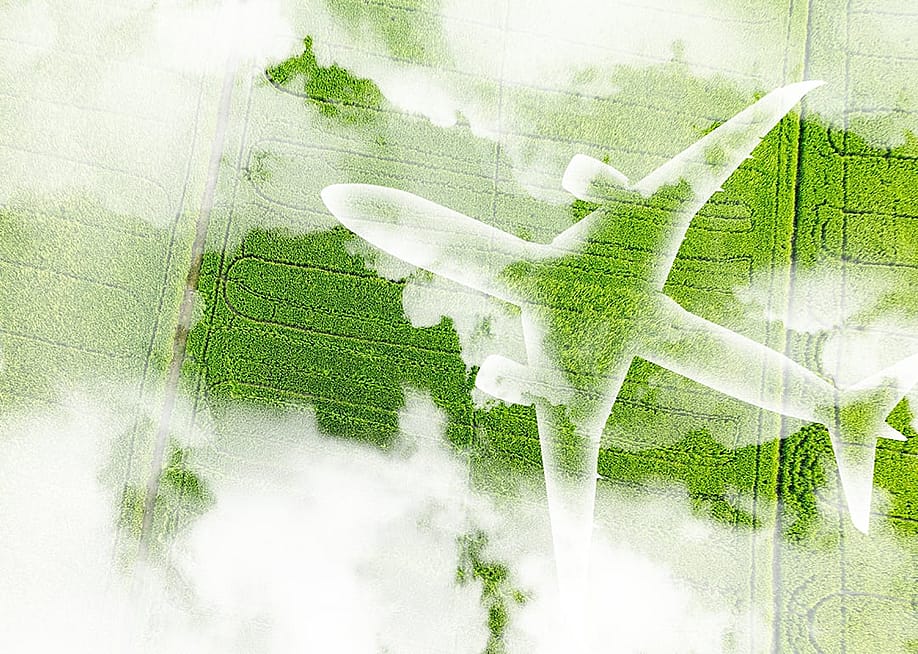 A figure of an airplane over a green field as a concept of sustainable aviation. — Fahroni // Shutterstock
