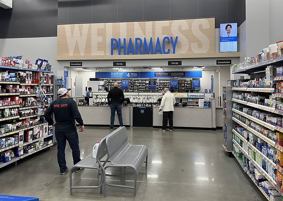 Customers picking up items at a pharmacy counter. — Quality HD // Shutterstock