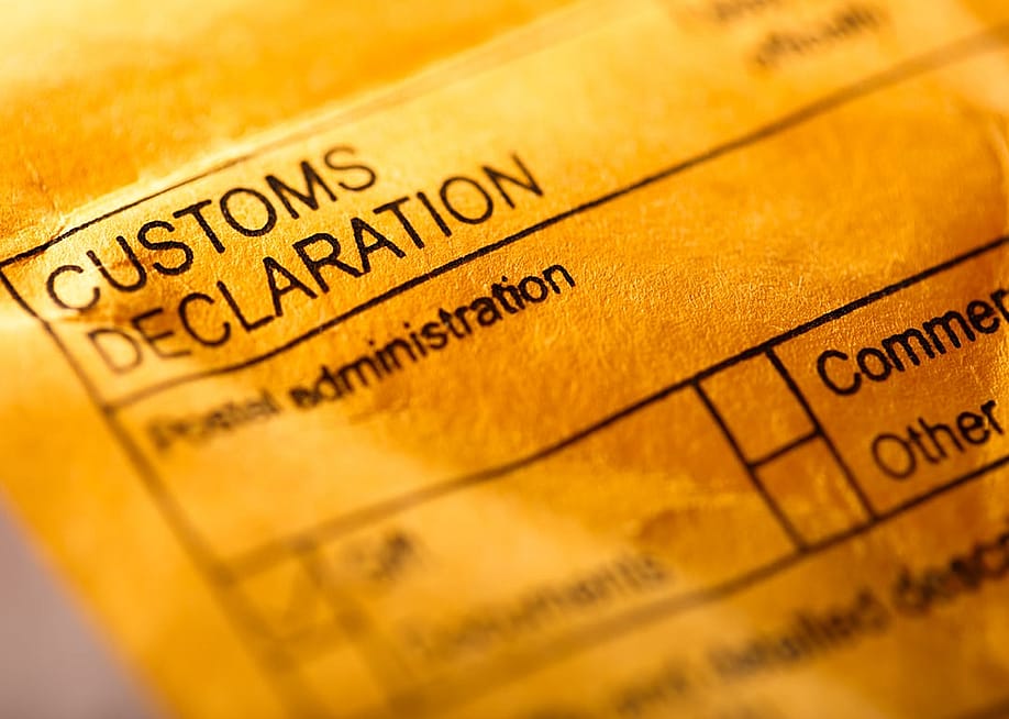 A post envelope closed up on the 'customs declaration' parts to fill out. — Garsya // Shutterstock