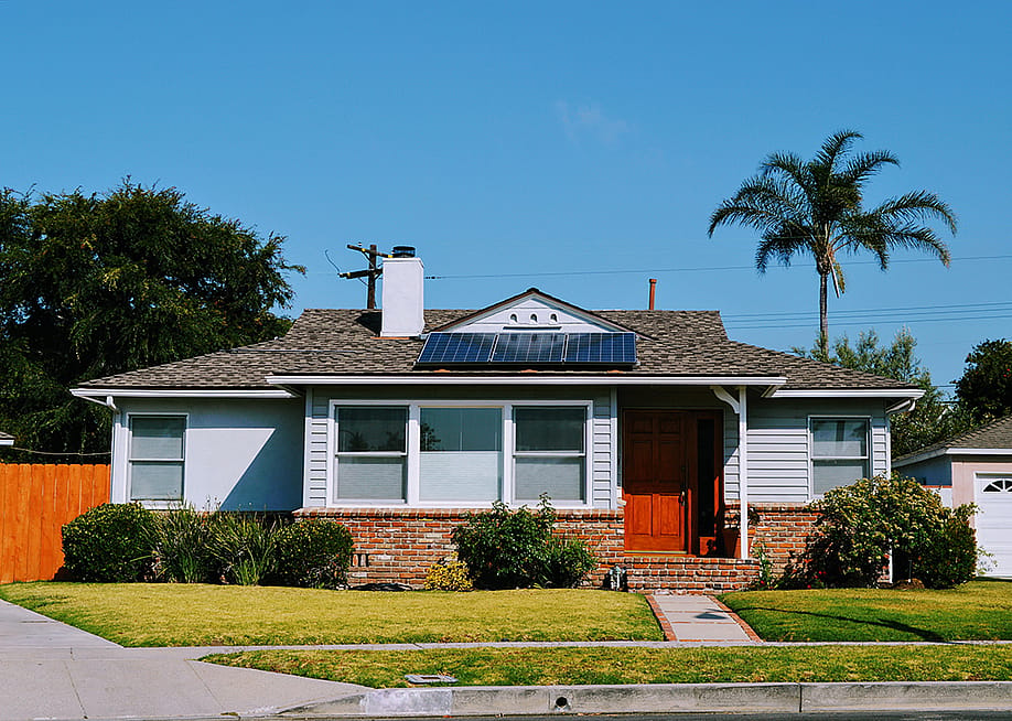 A modern cottage with solar roof panels. — divanov // Shutterstock
