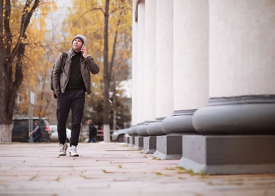 A man walking through the city during autumn. — alexkich // Shutterstock