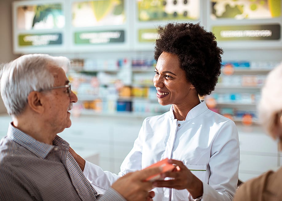 A female pharmacist helping senior customers. — Davor Geber // Shutterstock
