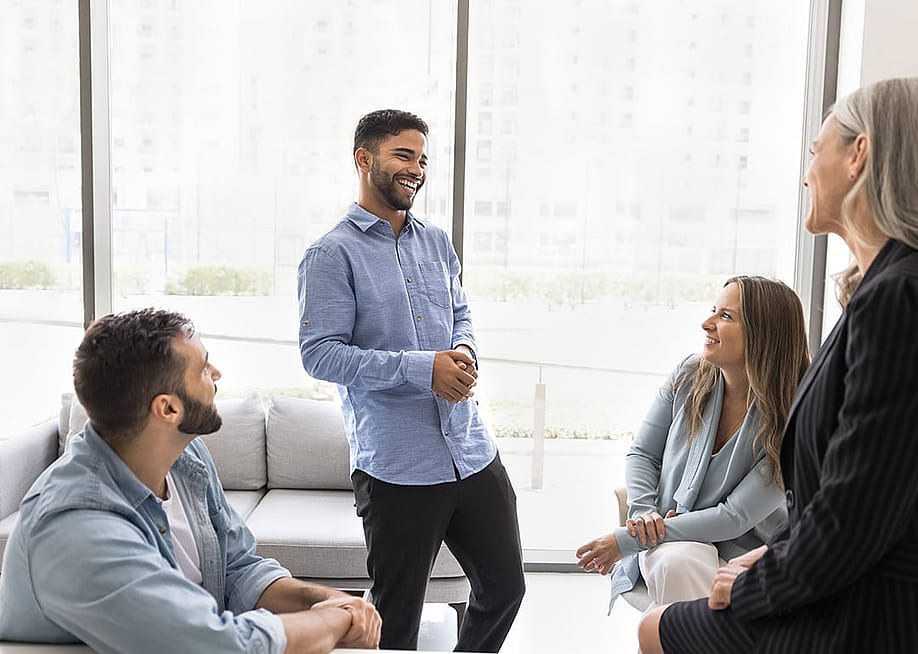 A company team laughing during their break. — fizkes // Shutterstock