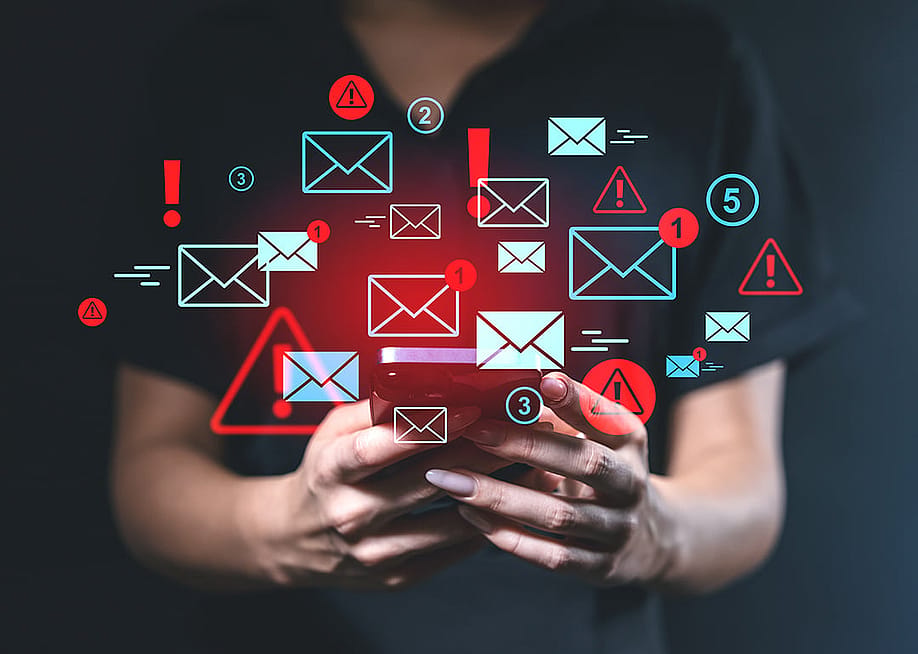 Person using a smartphone illustrated with blue and red email alert graphics. — ImageFlow // Shutterstock