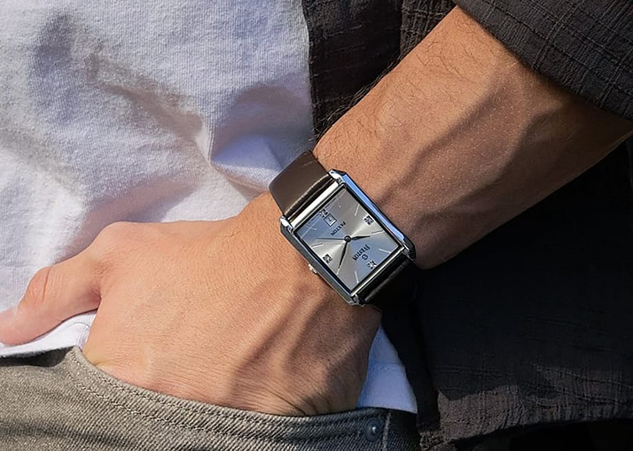 Close up on a man's wrist sporting a square watch. — Sveston Watches
