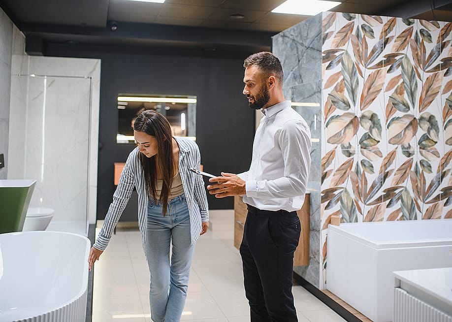A young couple choosing new bathroom furniture. — Hryshchyshen Serhii // Shutterstock