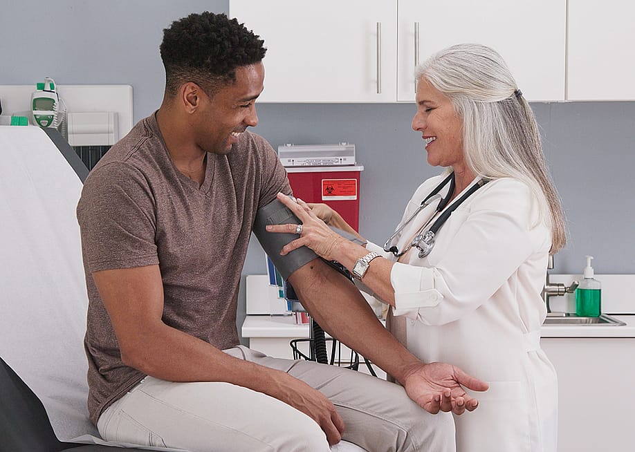A physician checking her patient's blood pressure. — Rocketclips, Inc. // Shutterstock